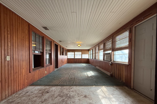 unfurnished sunroom featuring a baseboard heating unit, cooling unit, and visible vents