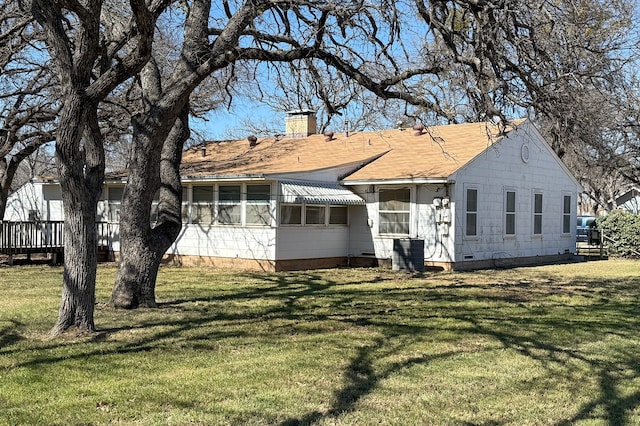 view of front of property with crawl space, a chimney, and a front lawn