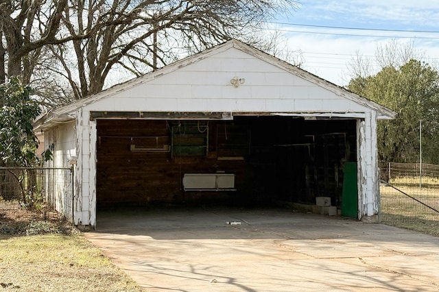 detached garage featuring fence