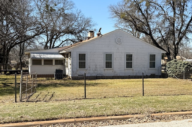 exterior space featuring central AC, a fenced front yard, and a front yard