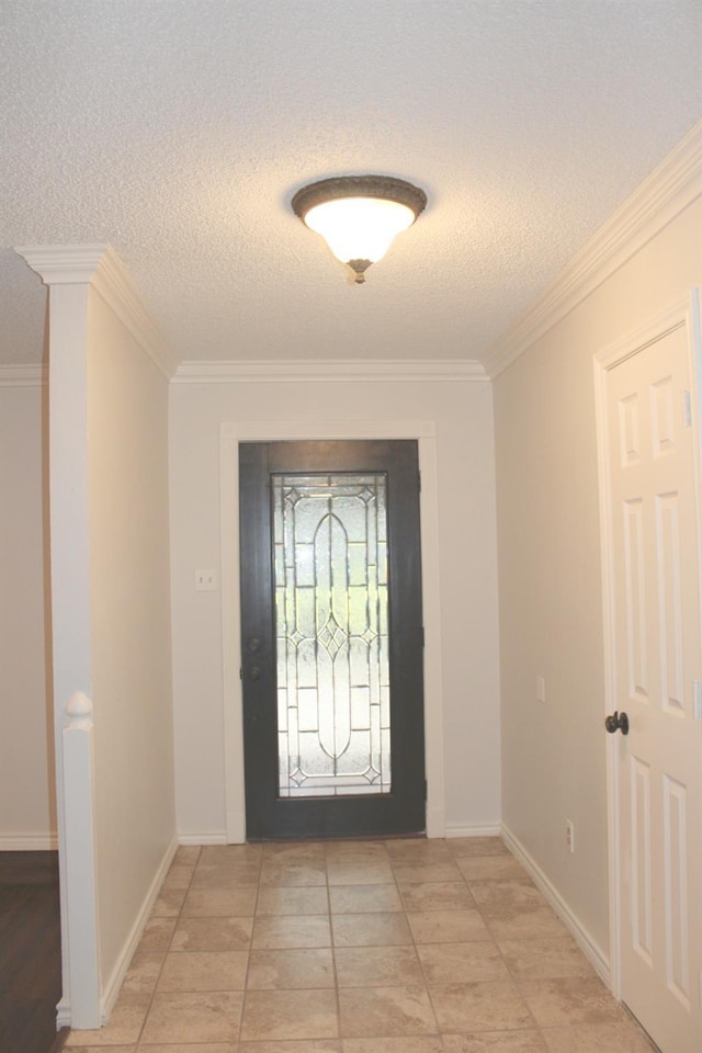 foyer with crown molding, a textured ceiling, and baseboards