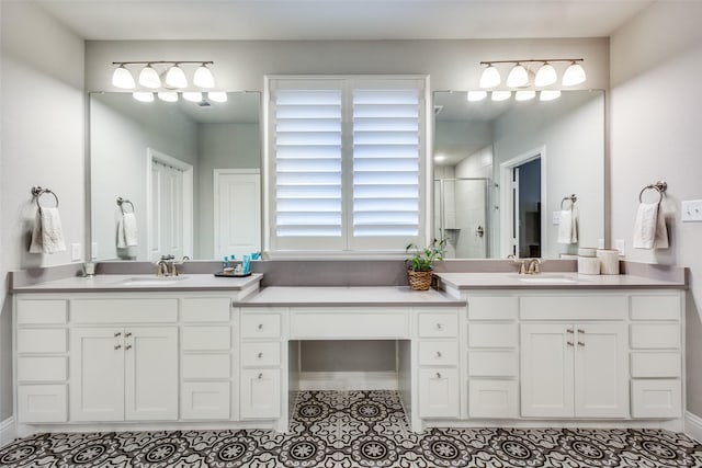 full bath with a stall shower, tile patterned flooring, and vanity