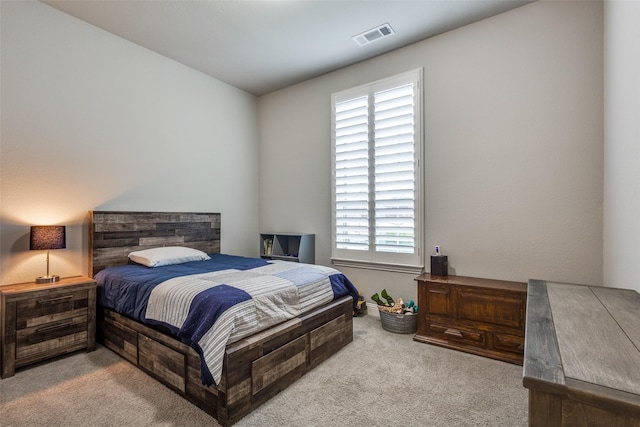 carpeted bedroom featuring visible vents