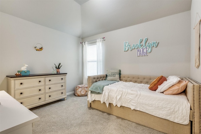 carpeted bedroom with lofted ceiling