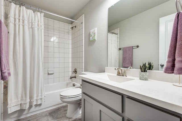 full bath with shower / bath combo, a textured wall, vanity, and toilet