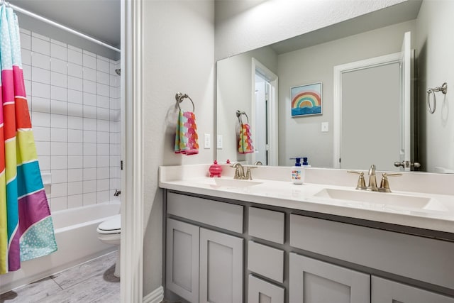 full bathroom with shower / bath combo with shower curtain, a sink, toilet, and double vanity