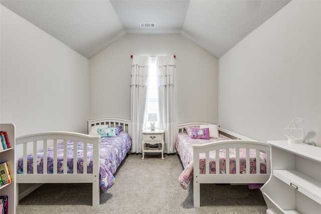 carpeted bedroom with vaulted ceiling and visible vents