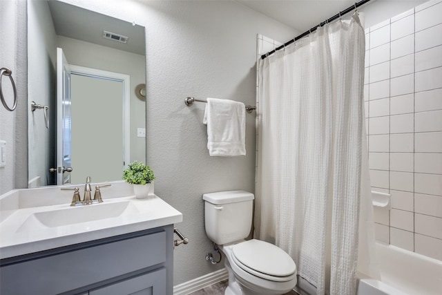 bathroom featuring visible vents, a textured wall, toilet, shower / tub combo with curtain, and vanity