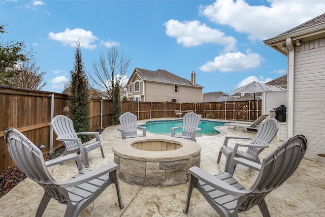 view of patio featuring a fenced in pool, a fenced backyard, and a fire pit