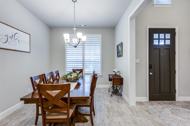 dining space with visible vents, a notable chandelier, and baseboards