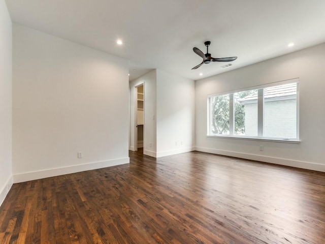 empty room featuring dark wood-type flooring, recessed lighting, visible vents, and baseboards