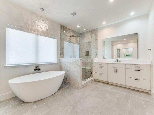 bathroom with a marble finish shower, recessed lighting, visible vents, a freestanding bath, and vanity