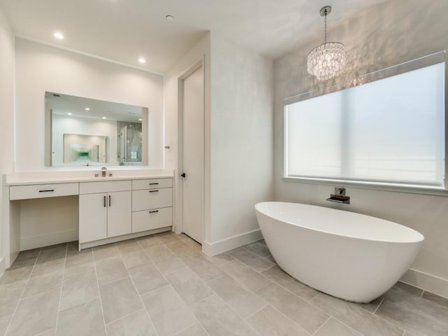 full bathroom with a freestanding bath, recessed lighting, vanity, and baseboards