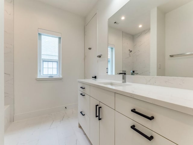 bathroom with recessed lighting, vanity, baseboards, marble finish floor, and a marble finish shower