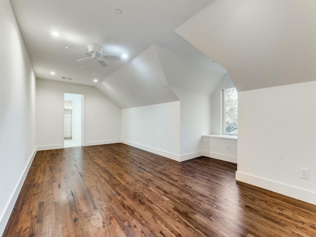 additional living space with lofted ceiling, dark wood finished floors, baseboards, and ceiling fan