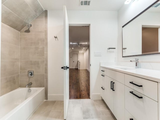 bathroom with tile patterned flooring, washtub / shower combination, visible vents, and vanity