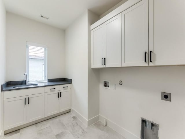 washroom with gas dryer hookup, a sink, visible vents, cabinet space, and electric dryer hookup