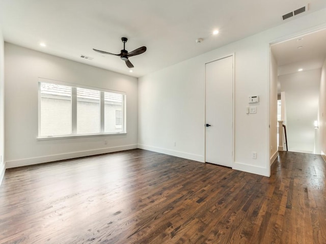 unfurnished room with dark wood-style flooring, recessed lighting, visible vents, a ceiling fan, and baseboards