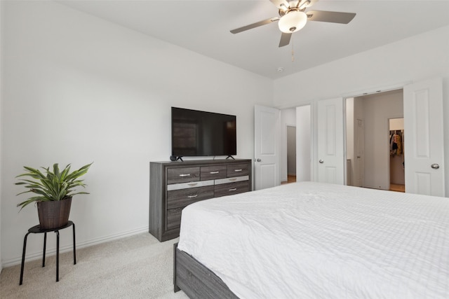 bedroom featuring baseboards, a ceiling fan, and light colored carpet