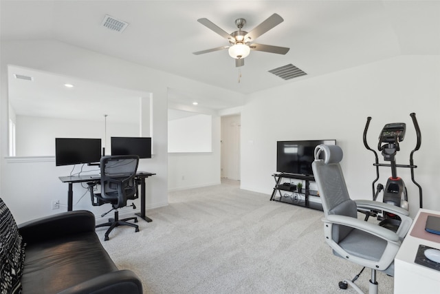 carpeted home office with visible vents, vaulted ceiling, and ceiling fan