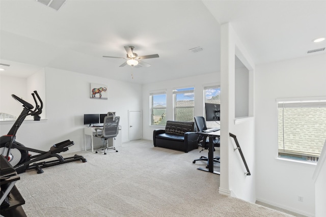 carpeted office space with visible vents and ceiling fan