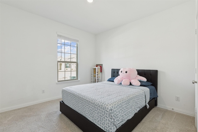 bedroom with carpet floors and baseboards