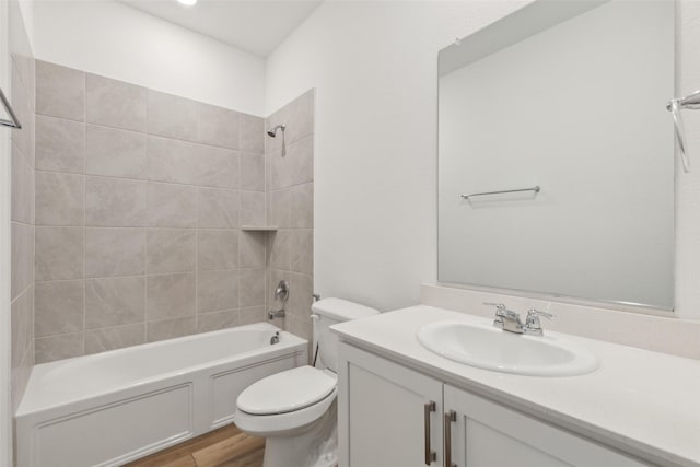 full bathroom featuring  shower combination, vanity, wood finished floors, and toilet