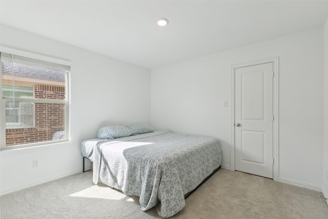 bedroom featuring carpet and baseboards