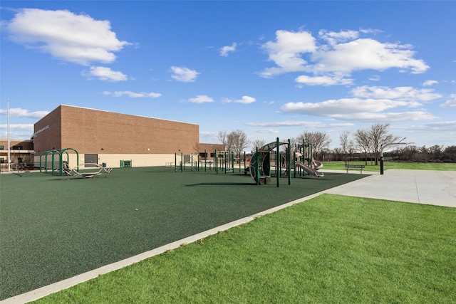 view of property's community featuring playground community and a yard