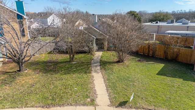 view of front of home with fence and a front lawn