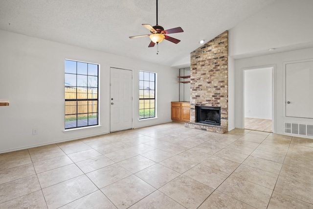 unfurnished living room with vaulted ceiling, light tile patterned flooring, and a brick fireplace