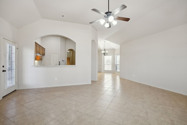 unfurnished living room with lofted ceiling, light tile patterned floors, baseboards, and ceiling fan with notable chandelier