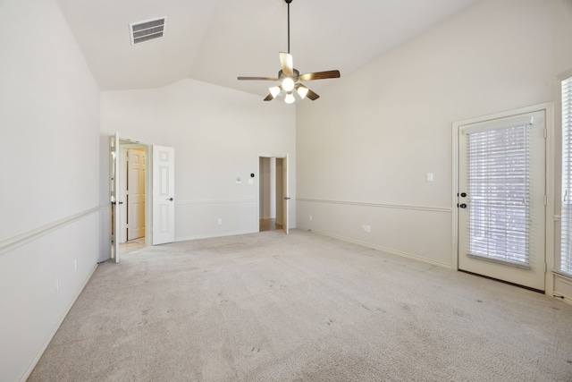 spare room with visible vents, a ceiling fan, carpet flooring, high vaulted ceiling, and baseboards