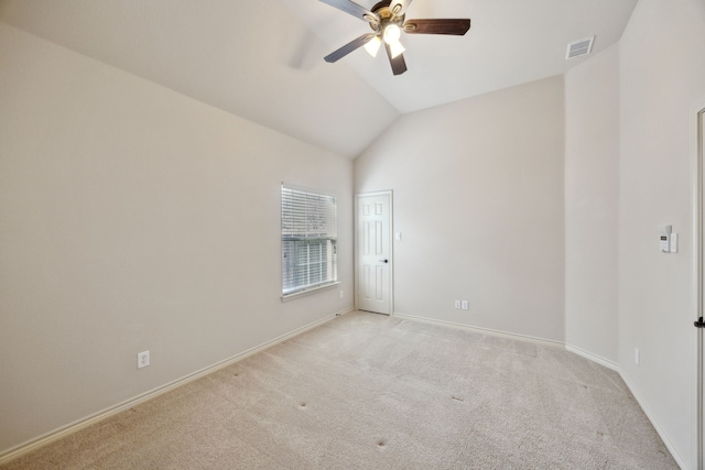 spare room with light carpet, baseboards, visible vents, ceiling fan, and vaulted ceiling