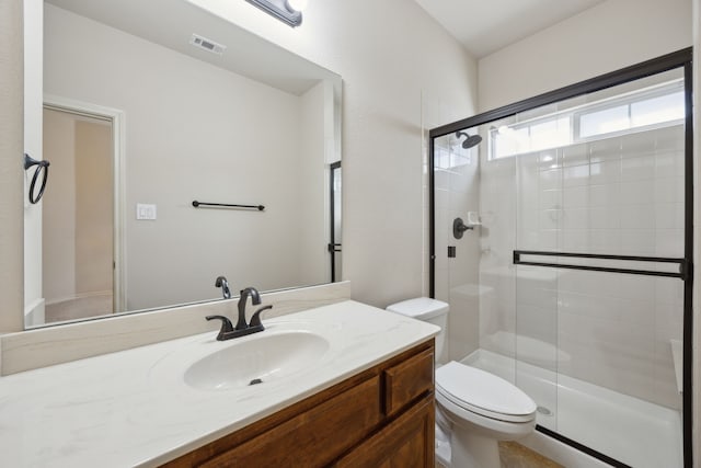 bathroom featuring toilet, a shower stall, visible vents, and vanity