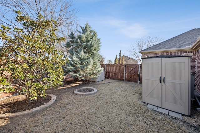 view of yard featuring a fenced backyard, an outdoor structure, and a shed