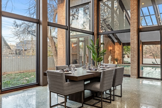 sunroom featuring visible vents and a healthy amount of sunlight