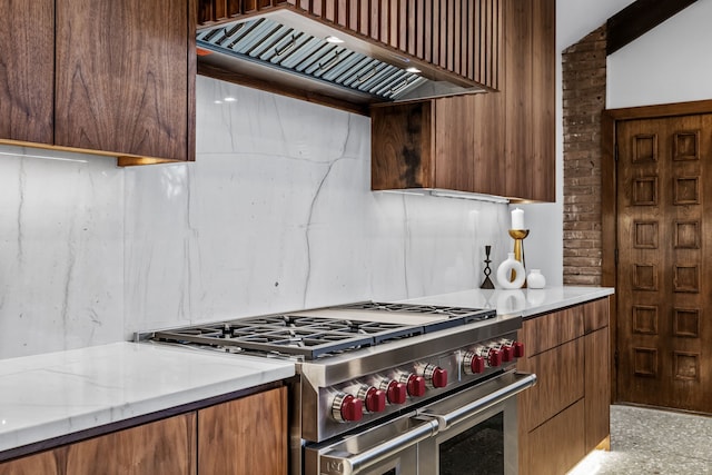 kitchen with range with two ovens, light stone countertops, custom exhaust hood, and modern cabinets