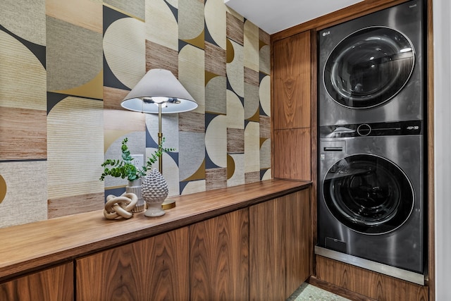 laundry room featuring stacked washer and clothes dryer and laundry area