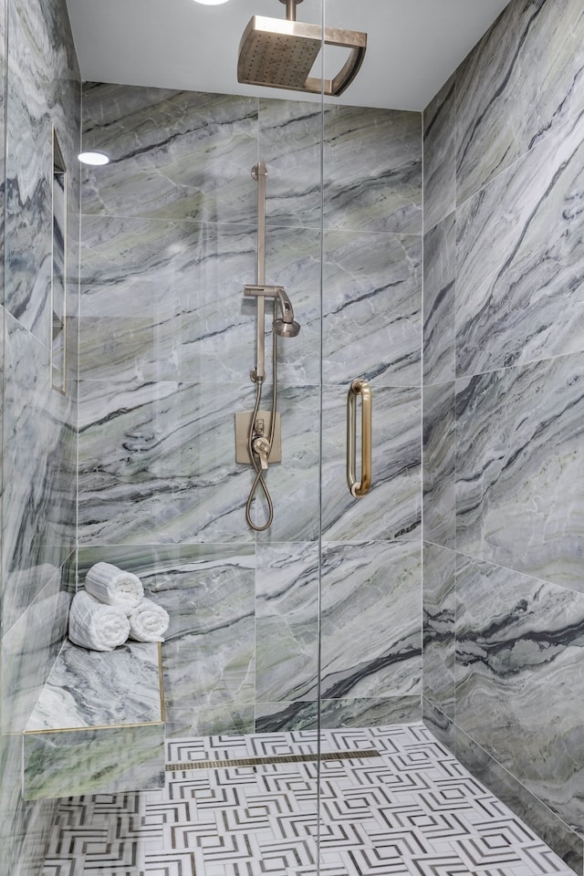 full bath with a marble finish shower