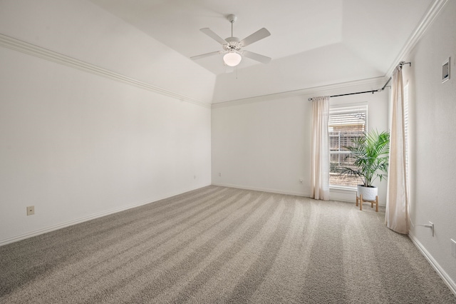 spare room featuring light carpet, baseboards, ceiling fan, and vaulted ceiling