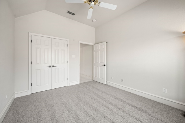 unfurnished bedroom featuring a closet, carpet flooring, visible vents, and lofted ceiling