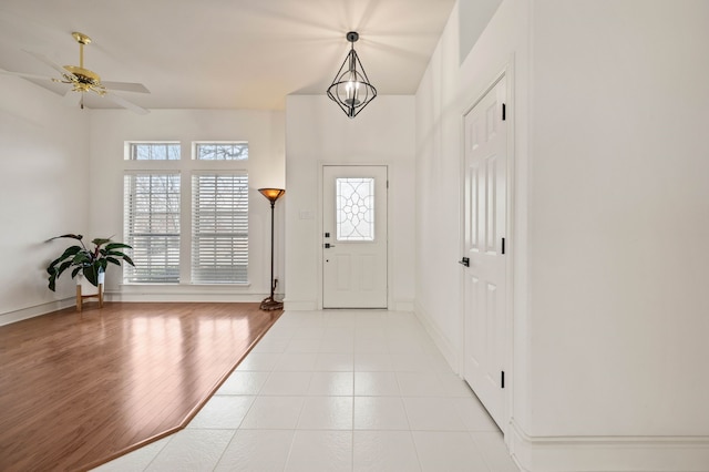 foyer entrance featuring light wood-type flooring, baseboards, and a healthy amount of sunlight