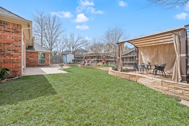 view of yard featuring a storage shed, a patio, a fenced backyard, and an outbuilding