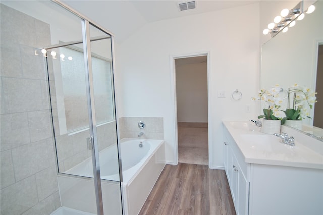 bathroom featuring visible vents, a stall shower, a sink, and a bath