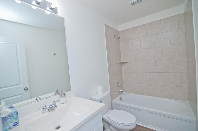 bathroom featuring visible vents, bathing tub / shower combination, toilet, and vanity