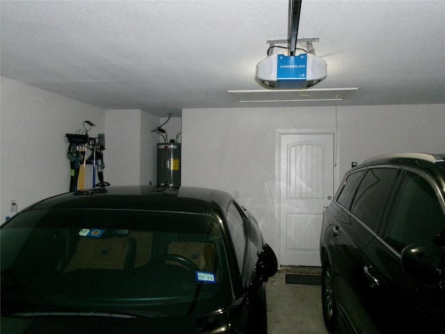 garage featuring a garage door opener and electric water heater