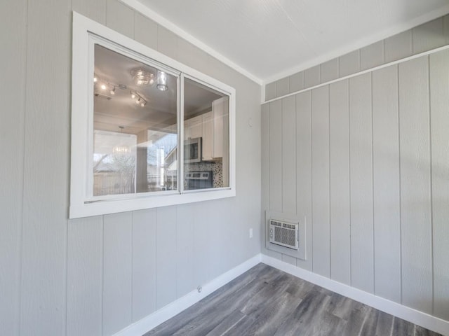 unfurnished room with dark wood-style flooring and baseboards