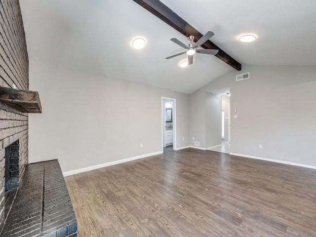 unfurnished living room with a fireplace, visible vents, lofted ceiling with beams, wood finished floors, and baseboards