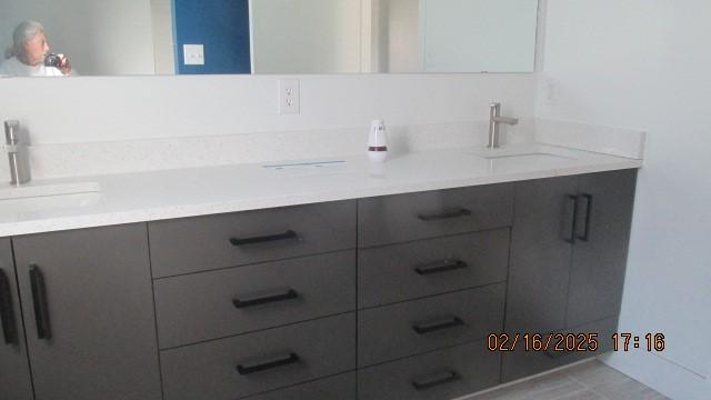 full bath with double vanity and a sink